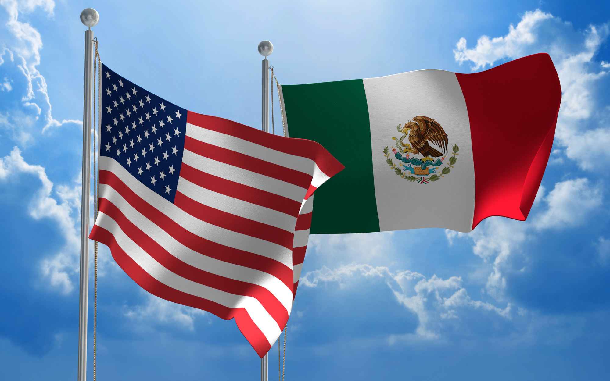 Banderas ondeando de Estados Unidos y México